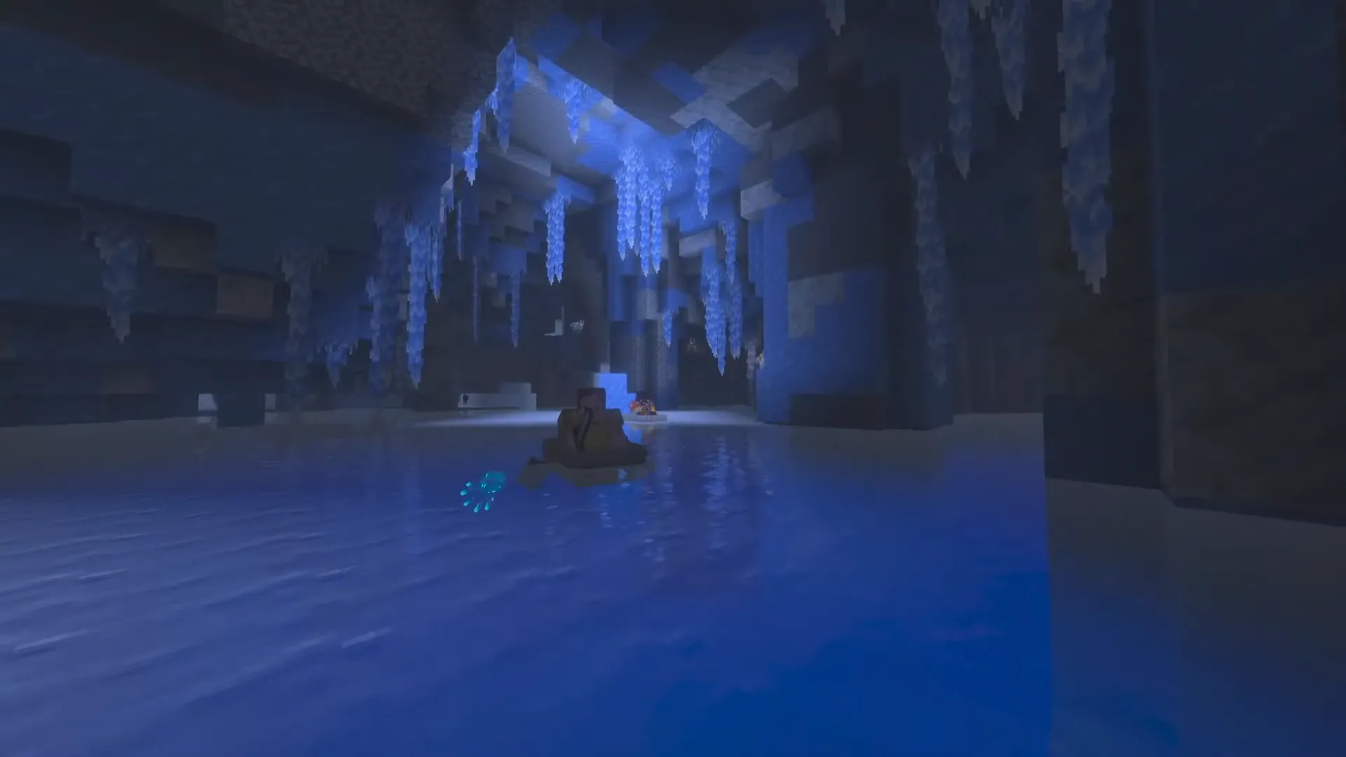 Łódka w zalanych Ice Caves ze świecącymi lodowymi kryształami i glow squid